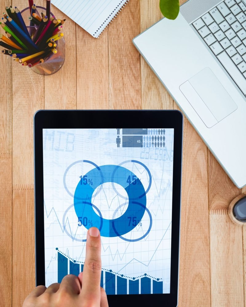 composite of hands using tablet computer with desk background